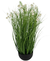 De Kunstgras witte Gesang Bloem uiengraspot is een 90cm brandvertragende kunstplant met lange, dunne groene bladeren en delicate witte bloemen in een ronde zwarte pot, tegen een effen witte achtergrond.